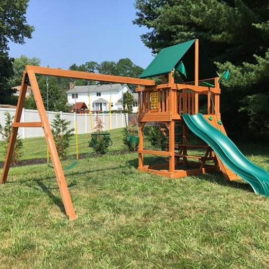 Chateau swing set with nylon canopy in backyard