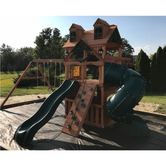 mountaineer clubhouse swing set with malibu roof in the backyard