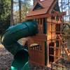 Image of mountaineer clubhouse swing set with treehouse roof in the backyard