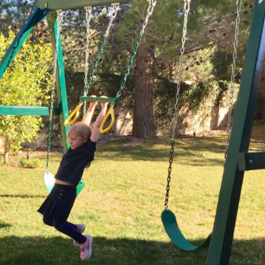 kid on congo swing central swing set trapeze bar